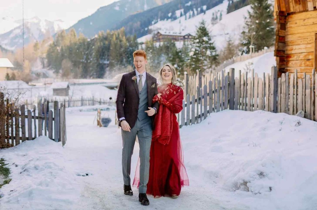 bride wearing holiday cherry hued dress winter wonderland best Christmas wedding ideas